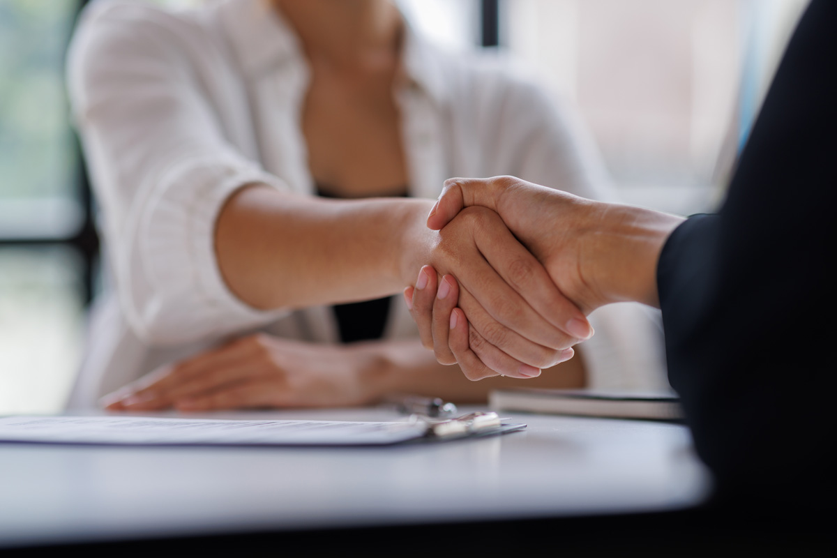 A divorce attorney shaking hands with a client in El Paso.